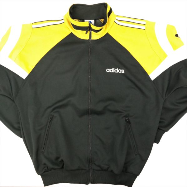 old school training jacket from adidas in black with yellow shoulders and logo